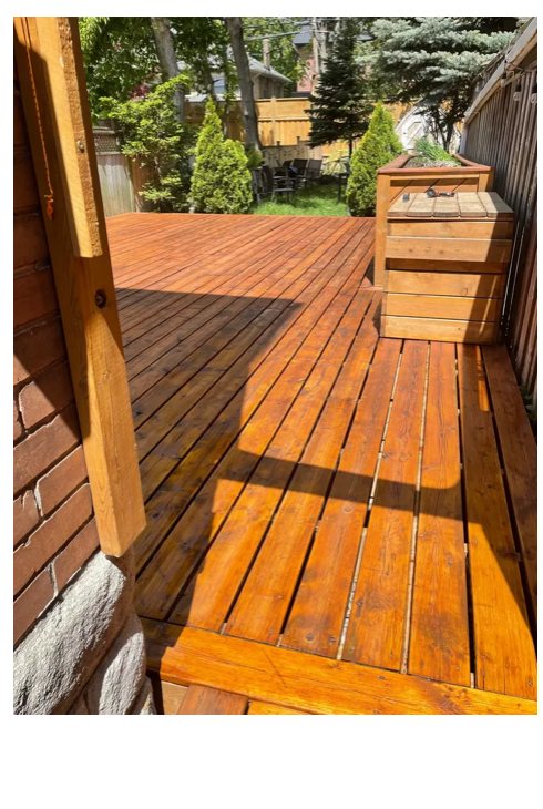 A freshly restored and stained backyard deck by Demo Plus